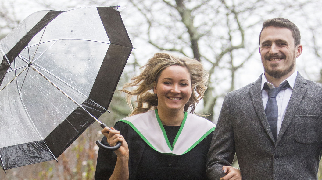 Couple holding umbrella at Stirling University Graduation Winter 2015