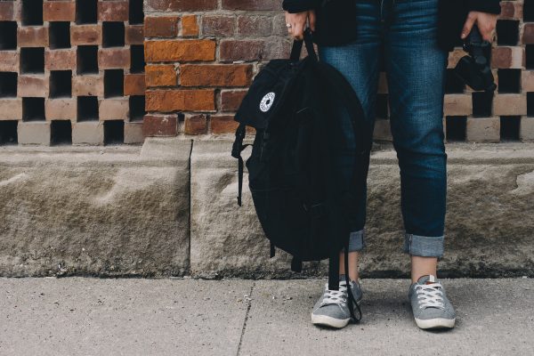 Students legs with bookbag