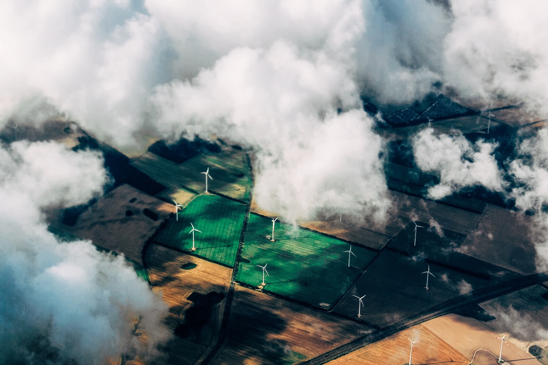 arial view of windfarms with clouds in the sky