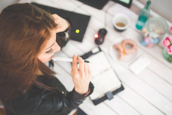 Return to study - a female student studying with books and notepads.