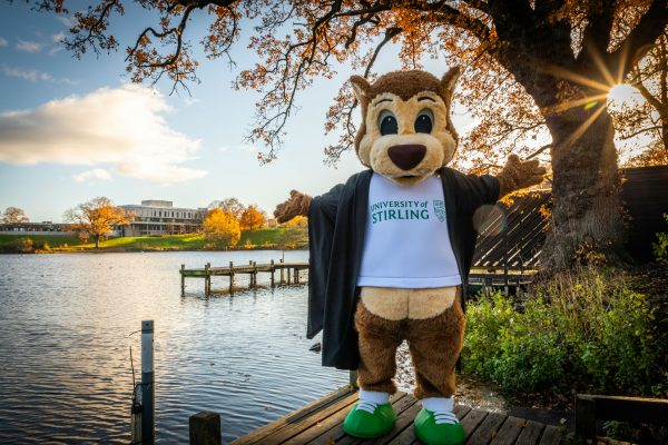 Stirling squirrel poses infront of Stirling campus next to Airthrey Loch