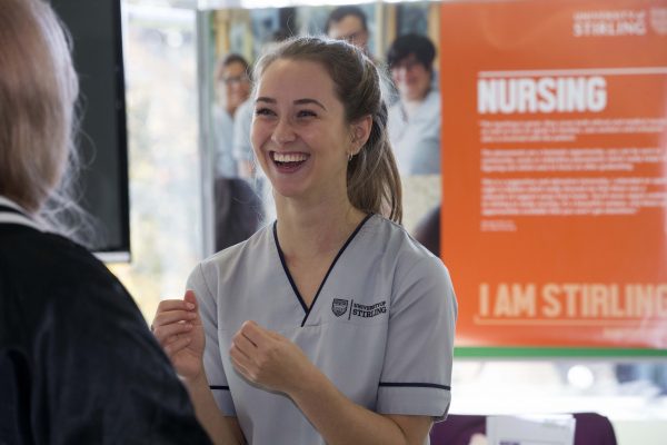 A University of Stirling student talks to prospective students at Applicant Day.