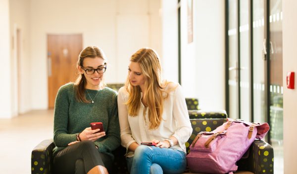 Two female Stirling students look at a mobile phone