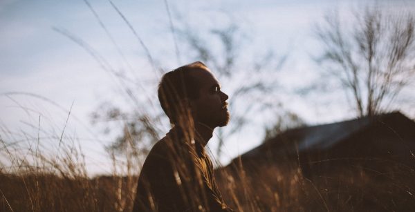 man meditating outside university mental health day